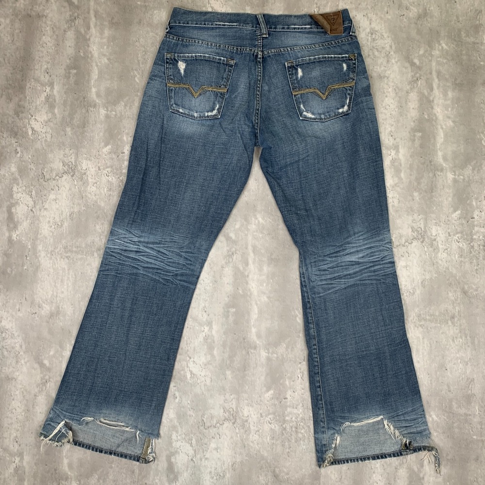 Guess Blue Bootcut Jeans with Distressed Hem and Back Pocket Detail